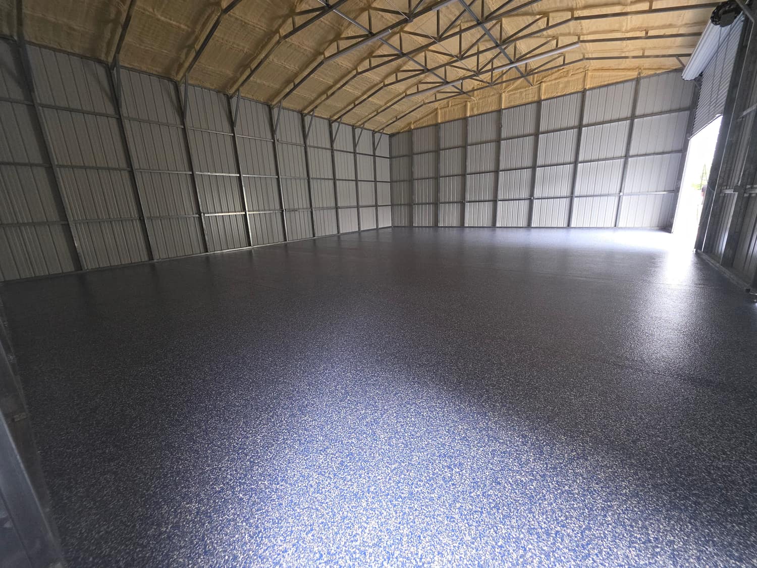 Grey flake floor coating in a metal pole barn workshop