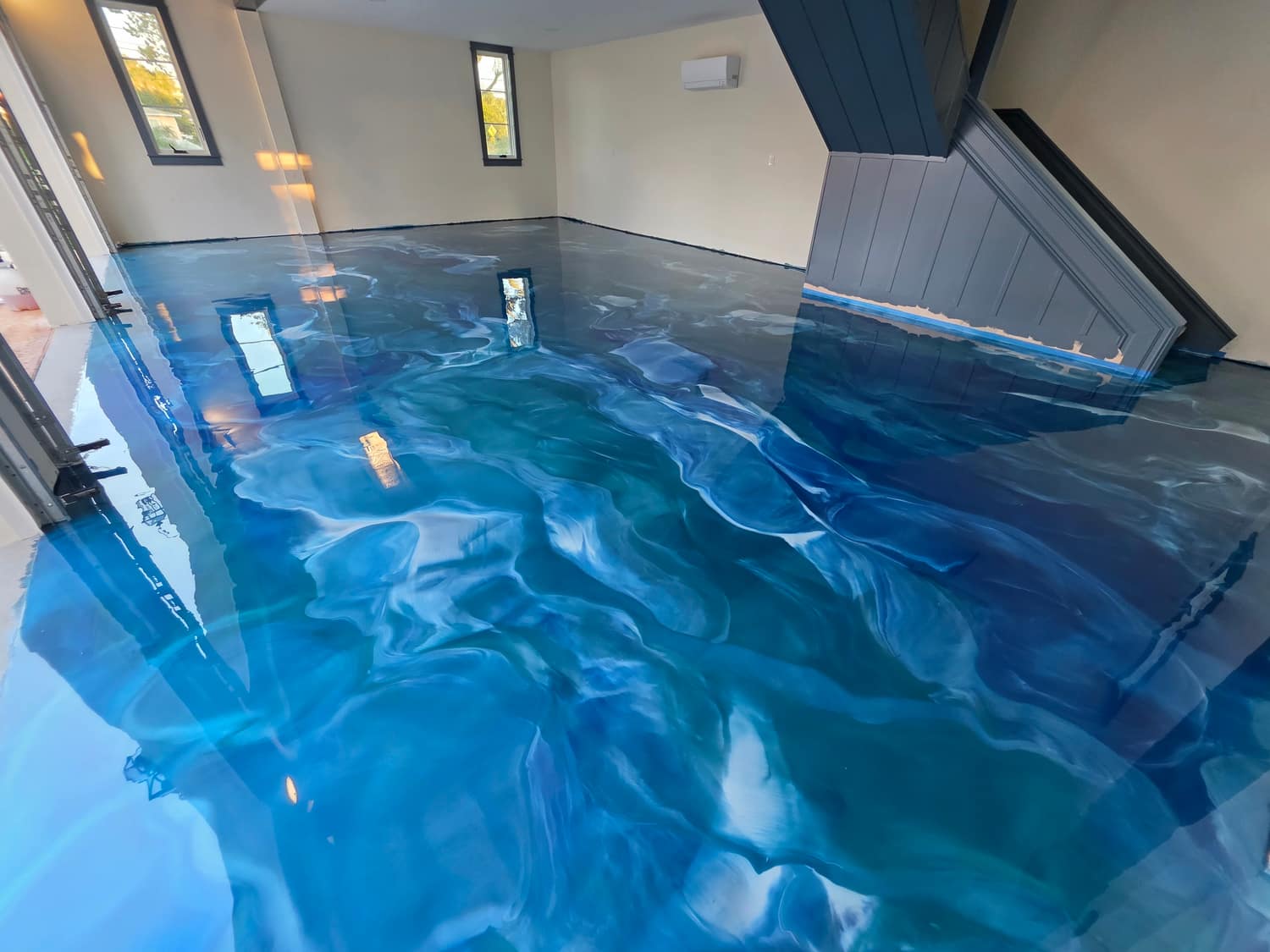 Blue and white metallic epoxy floor in a finished interior room