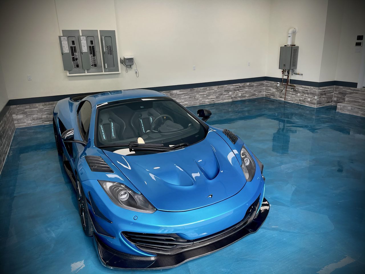 Blue metallic garage floor with McLaren