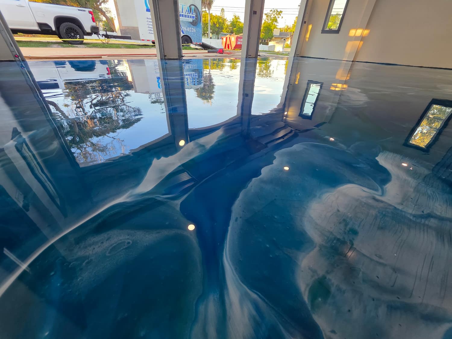 Blue and teal metallic floor in a commercial showroom with glass storefront
