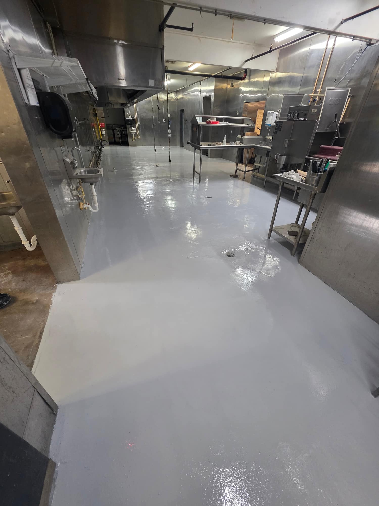 Grey solid color coating on a commercial kitchen floor