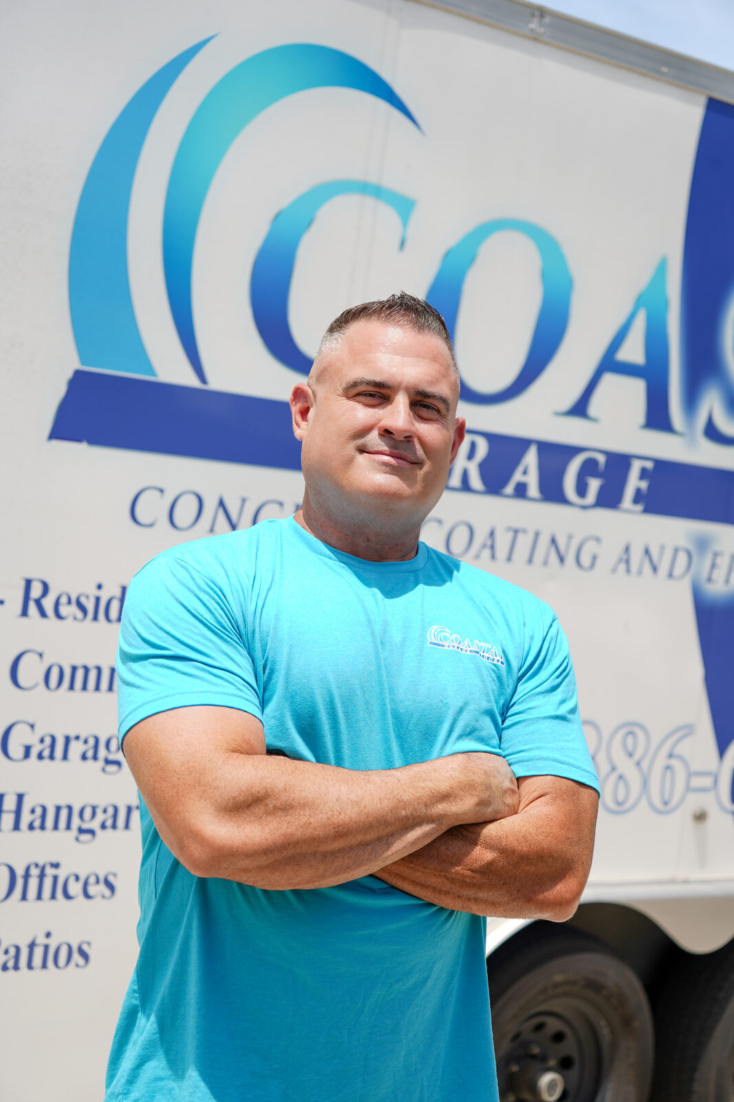 Ryan, owner of Coastal Garage Floors, in front of the company trailer